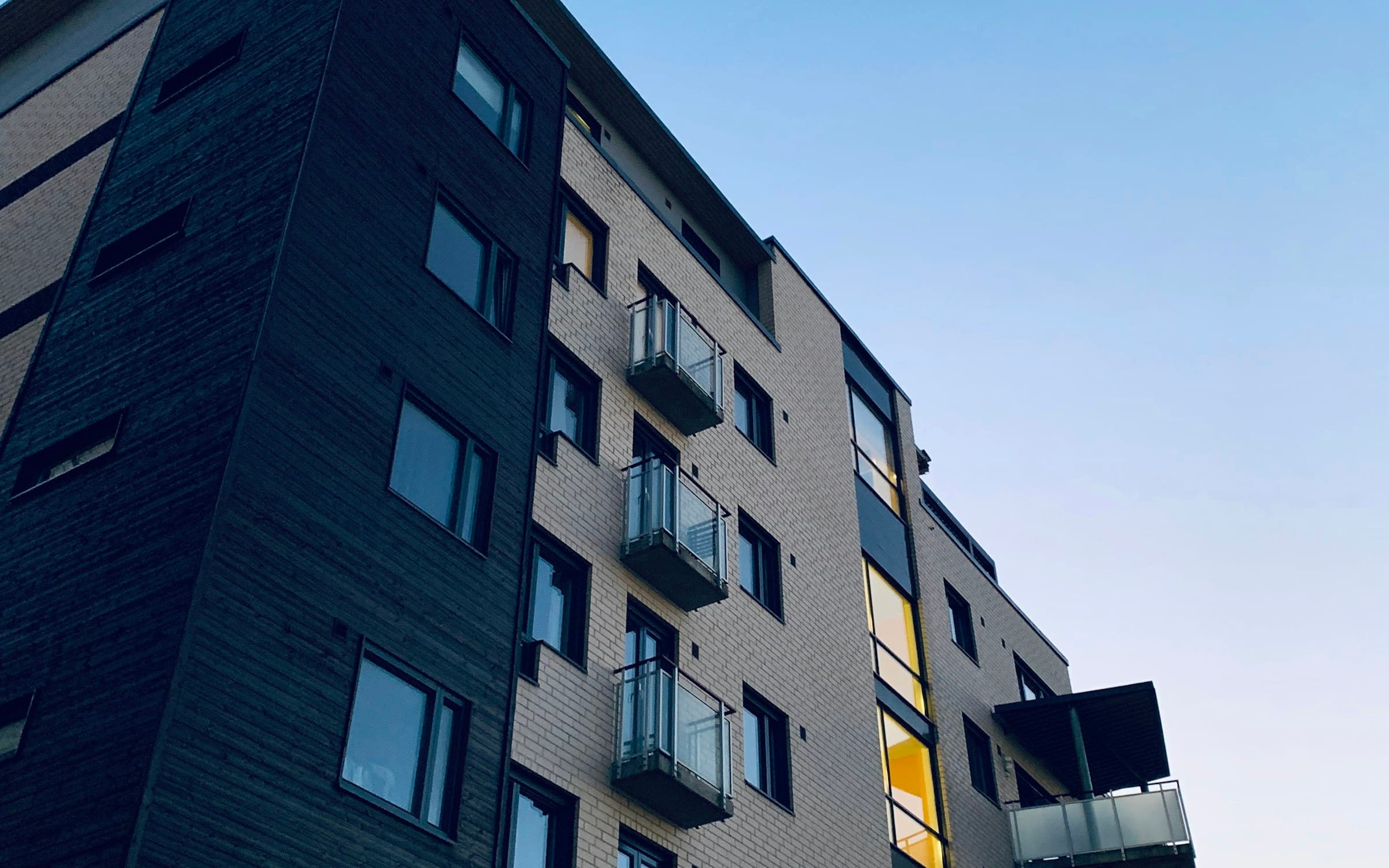Brick apartment building against a clear sky